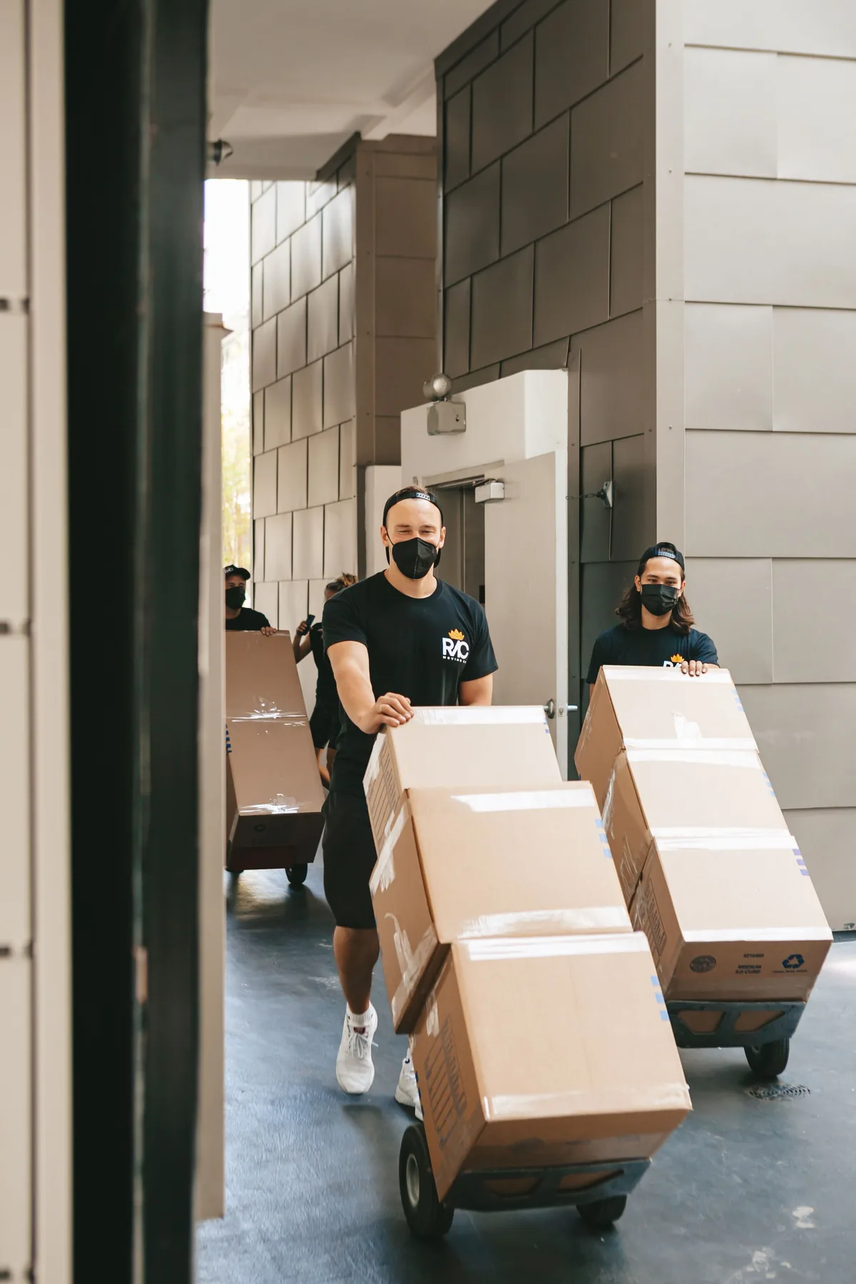 Movers using dollies to move boxes